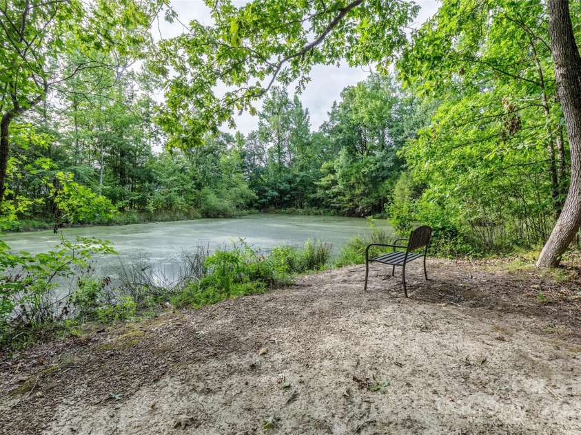 127 Tranquil Court, Locust, NC 28097.  MLS# CAR4152427, YatesRealty ID 1681. Pond at the end of nature trail