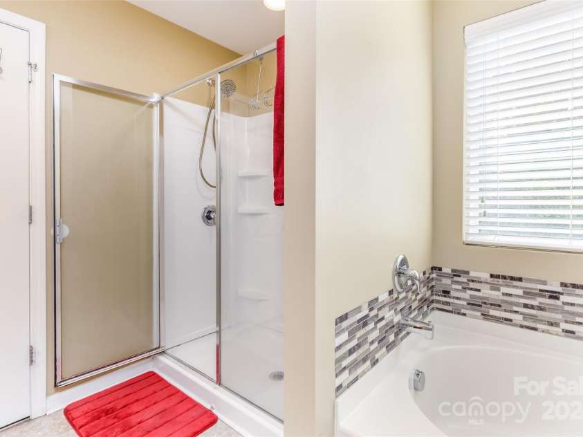 127 Tranquil Court, Locust, NC 28097.  MLS# CAR4152427, YatesRealty ID 1681. Primary Bedroom shower and garden tub