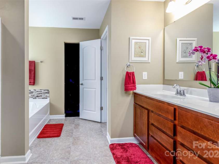 127 Tranquil Court, Locust, NC 28097.  MLS# CAR4152427, YatesRealty ID 1681. Primary Bedroom with en suite bathroom and large walk-in closet