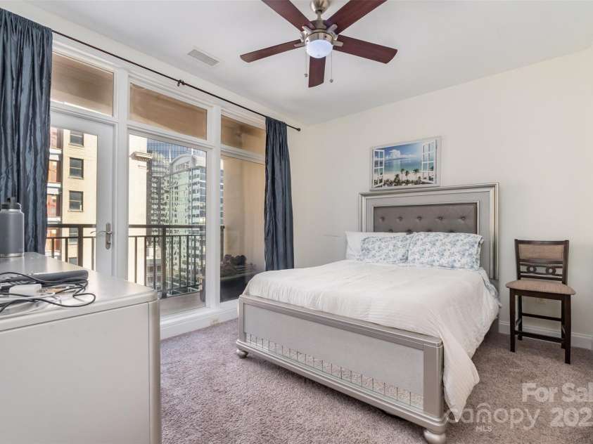 230 Tryon Street, Charlotte, NC 28202.  MLS# CAR4321048, YatesRealty ID 1683. Primary Bedroom with floor to ceiling windows / balcony access