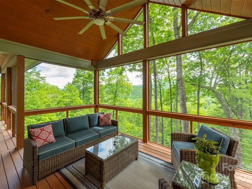 201 Ruffed Grouse Lane, Waynesville, NC 28786.  MLS# CAR4257615, YatesRealty ID 16833. Continued views from many screened deck areas