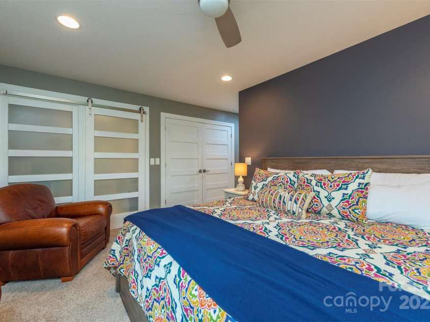 201 Ruffed Grouse Lane, Waynesville, NC 28786.  MLS# CAR4257615, YatesRealty ID 16833. Guest bedroom with large closet and barn door storage area