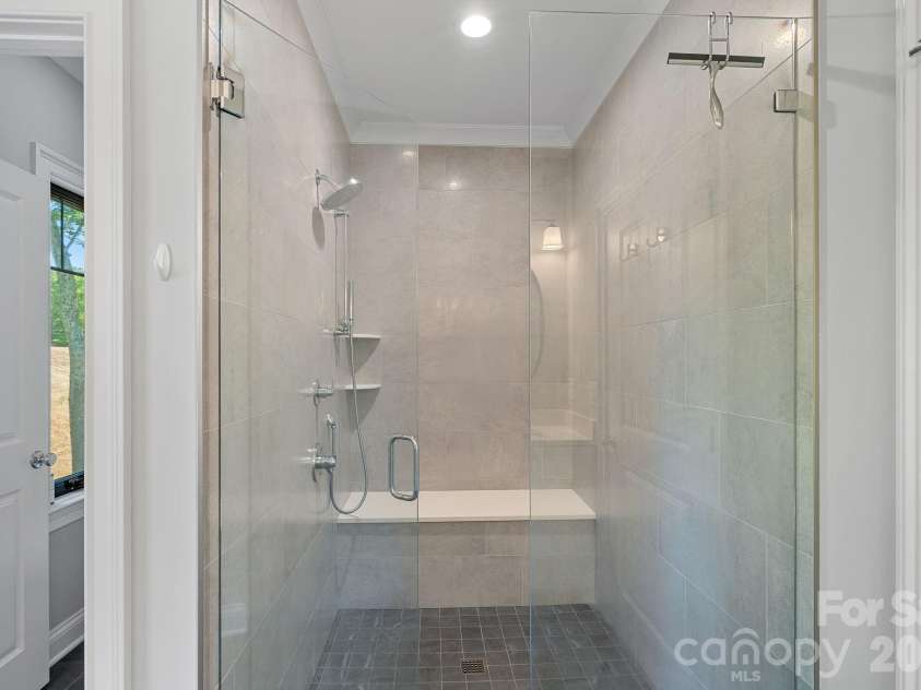 1420 Roundstone Road, Sherrills Ford, NC 28673.  MLS# CAR4369339, YatesRealty ID 16847. Tiled primary shower has a zero-entry access