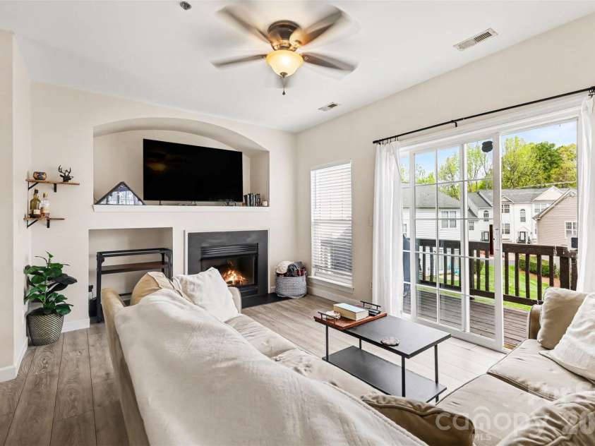 2729 Avalon Loop Road, Charlotte, NC 28269.  MLS# CAR4366095, YatesRealty ID 16859. The inviting living space features a thoughtfully designed layout with a spacious cut-out alcove perfect for a large television, complemented by a cozy fireplace that creates a warm focal point for relaxing evenings 