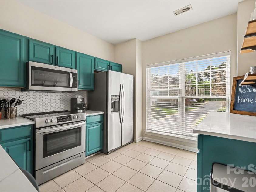 2729 Avalon Loop Road, Charlotte, NC 28269.  MLS# CAR4366095, YatesRealty ID 16859. Updated kitchen featuring modern finishes, abundant natural light from large windows, and an inviting open-concept living space.