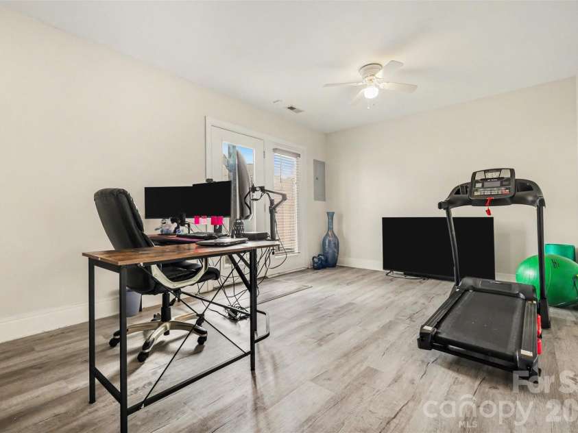 2729 Avalon Loop Road, Charlotte, NC 28269.  MLS# CAR4366095, YatesRealty ID 16859. Versatile lower-level bonus space with direct access to the private patio, offering the perfect area for a home office, gym, or additional living space.