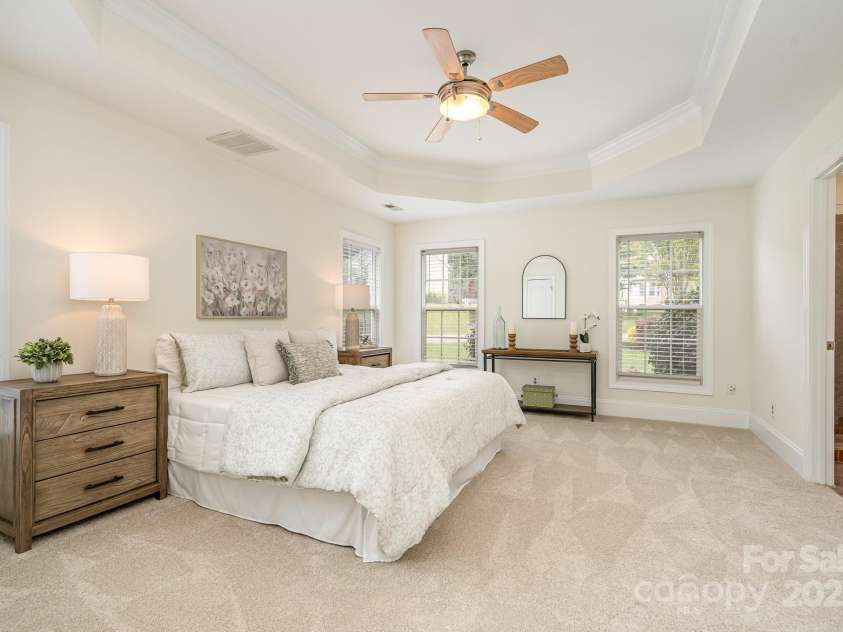 130 Hopedale Court, Mooresville, NC 28117.  MLS# CAR4245050, YatesRealty ID 16862. Stunning Primary Bedroom with fresh and new carpet, tray ceiling and plenty of windows