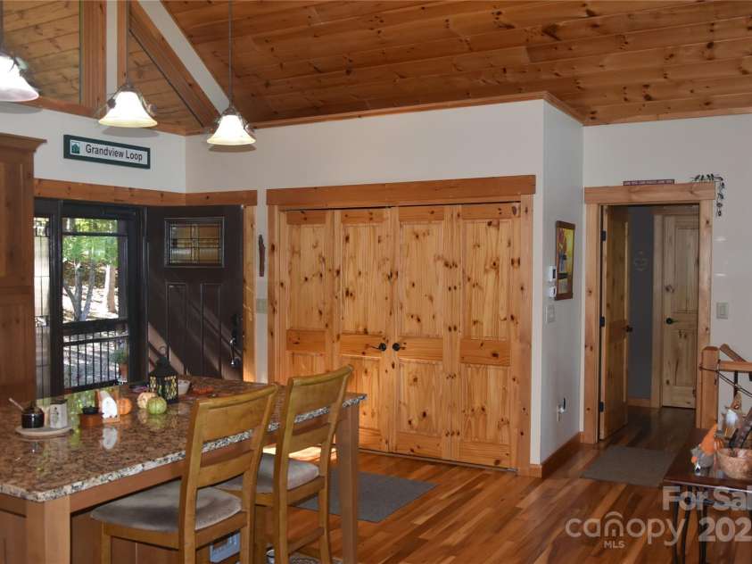 80 Grandview Loop, Nebo, NC 28761.  MLS# CAR4317495, YatesRealty ID 16868. Front door at the entrance of the great room kitchen and living area. The laundry room is behind the doors to the right of the front door.