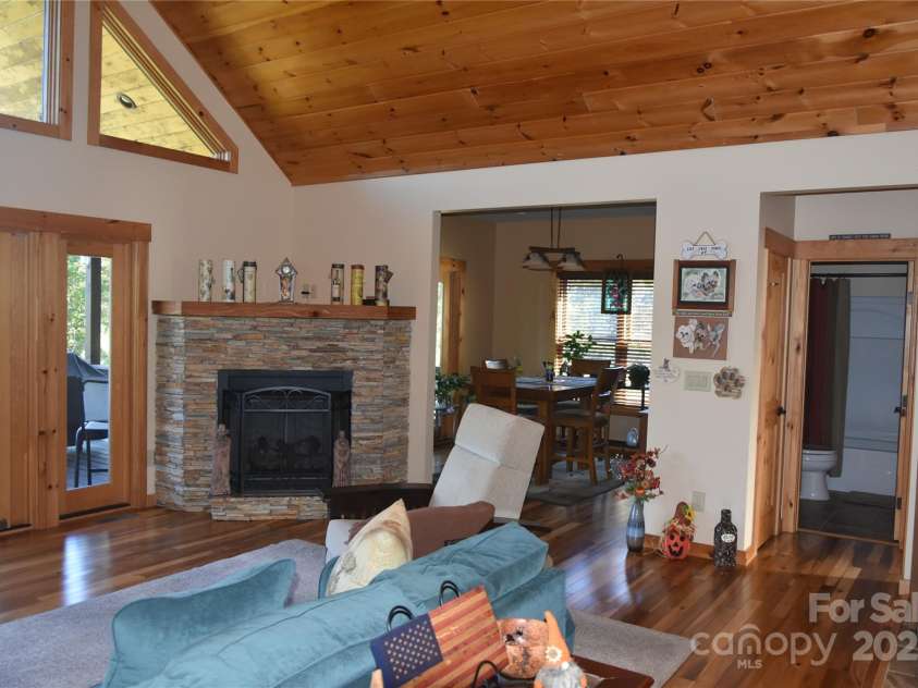 80 Grandview Loop, Nebo, NC 28761.  MLS# CAR4317495, YatesRealty ID 16868. Stone gas fireplace and view of the dining room.