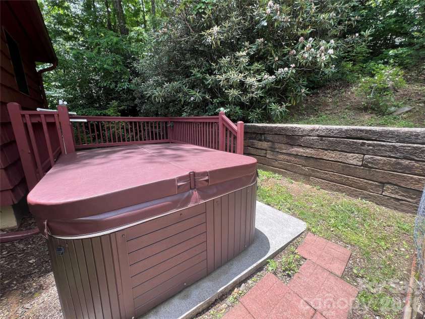 125 HEARTLAND Lane, Burnsville, NC 28714.  MLS# CAR4273356, YatesRealty ID 16873. Hot Tub among the Laurels.