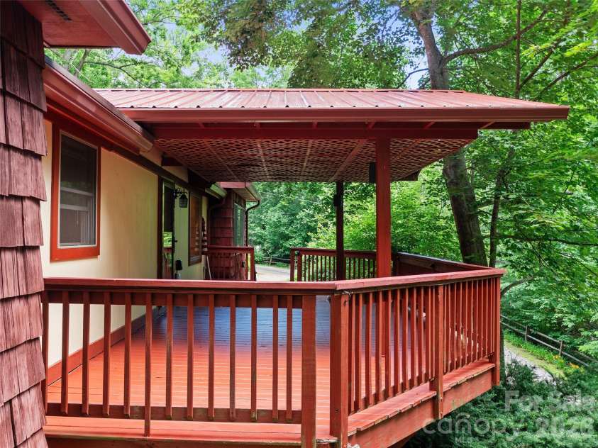 125 HEARTLAND Lane, Burnsville, NC 28714.  MLS# CAR4273356, YatesRealty ID 16873. Partially covered deck.