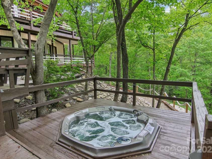 295 Dills Road, Bryson City, NC 28713.  MLS# CAR4280910, YatesRealty ID 16878. Hot tub out on the deck under the tree canopy