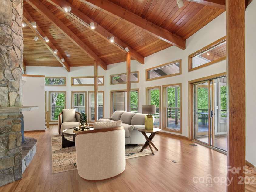 295 Dills Road, Bryson City, NC 28713.  MLS# CAR4280910, YatesRealty ID 16878. Virtually staged living area with the stone hearth as the focal point