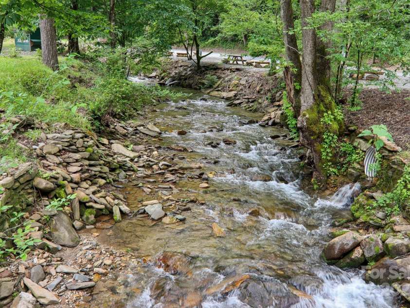 295 Dills Road, Bryson City, NC 28713.  MLS# CAR4280910, YatesRealty ID 16878. Wesser Creek at the bottom of the mountain