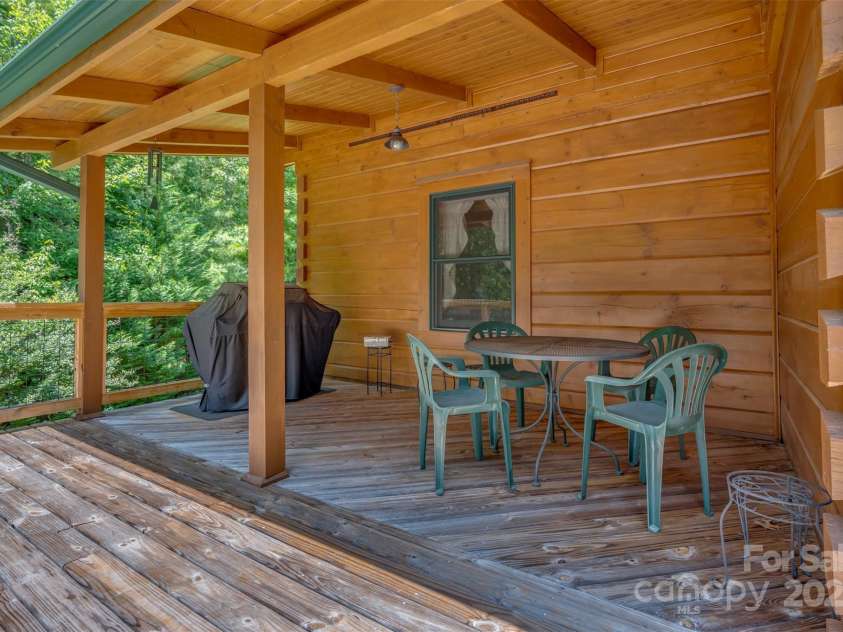 23 Jay Foster Way, Saluda, NC 28773.  MLS# CAR4278065, YatesRealty ID 1689. Covered Porch leads to rear deck that spans entire length of house and is directly outside of sliding glass door.