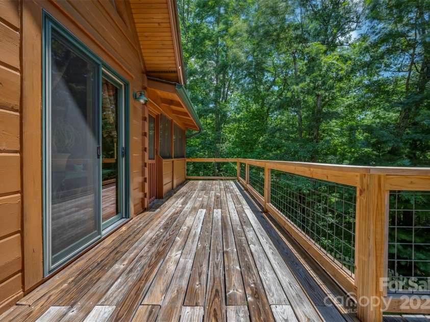 23 Jay Foster Way, Saluda, NC 28773.  MLS# CAR4278065, YatesRealty ID 1689. Deck View Towards screened porch.