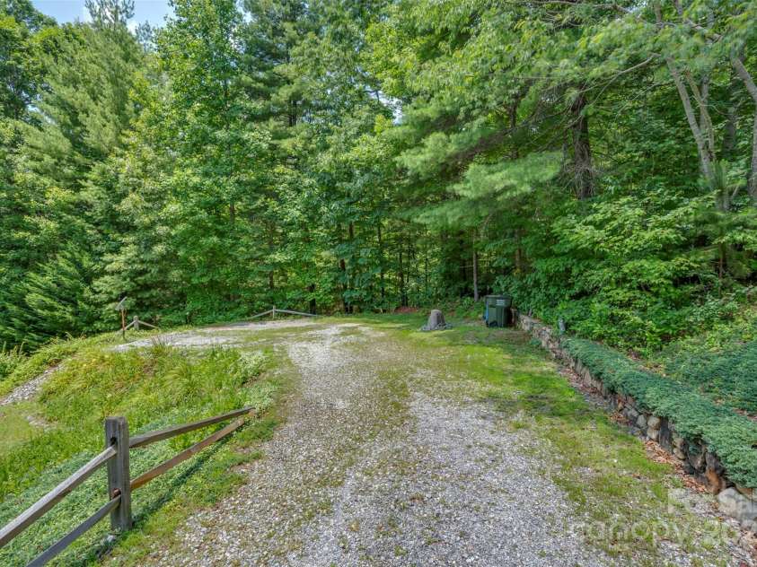 23 Jay Foster Way, Saluda, NC 28773.  MLS# CAR4278065, YatesRealty ID 1689. Flat driveway in to parking area.   Plenty of parking for guests in driveway