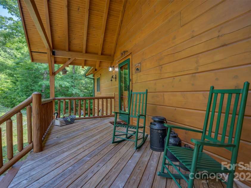 23 Jay Foster Way, Saluda, NC 28773.  MLS# CAR4278065, YatesRealty ID 1689. Inviting rocking chair front porch