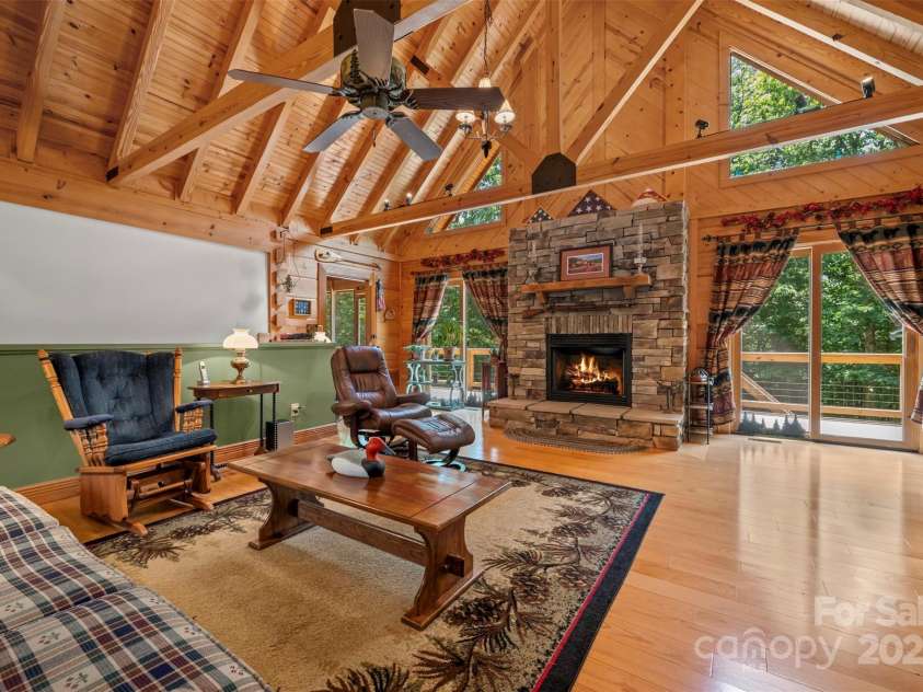 23 Jay Foster Way, Saluda, NC 28773.  MLS# CAR4278065, YatesRealty ID 1689. Triangular Windows and Two sets of sliding glass doors let in natural light!  Door to left leads to screened porch, perfect for bringing the outdoors inside!