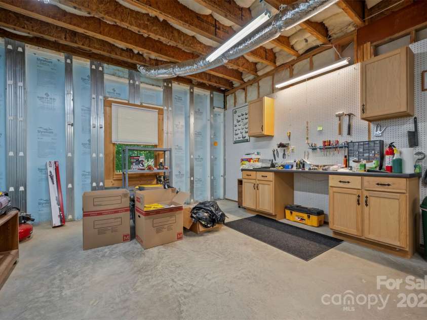 23 Jay Foster Way, Saluda, NC 28773.  MLS# CAR4278065, YatesRealty ID 1689. Workshop has work desk and cabinetry built in.