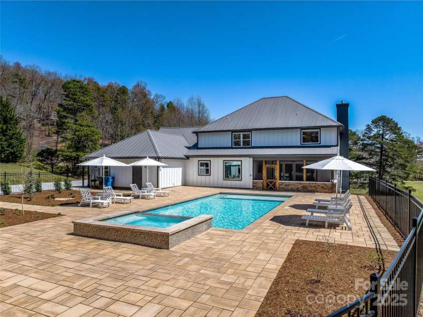 59 Bradford Hill Road, Mills River, NC 28759.  MLS# CAR4241459, YatesRealty ID 16892. Extensive pool patio creates room for guests.