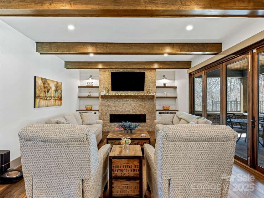 59 Bradford Hill Road, Mills River, NC 28759.  MLS# CAR4241459, YatesRealty ID 16892. Living room w/ gas fireplace and warm rustic accents