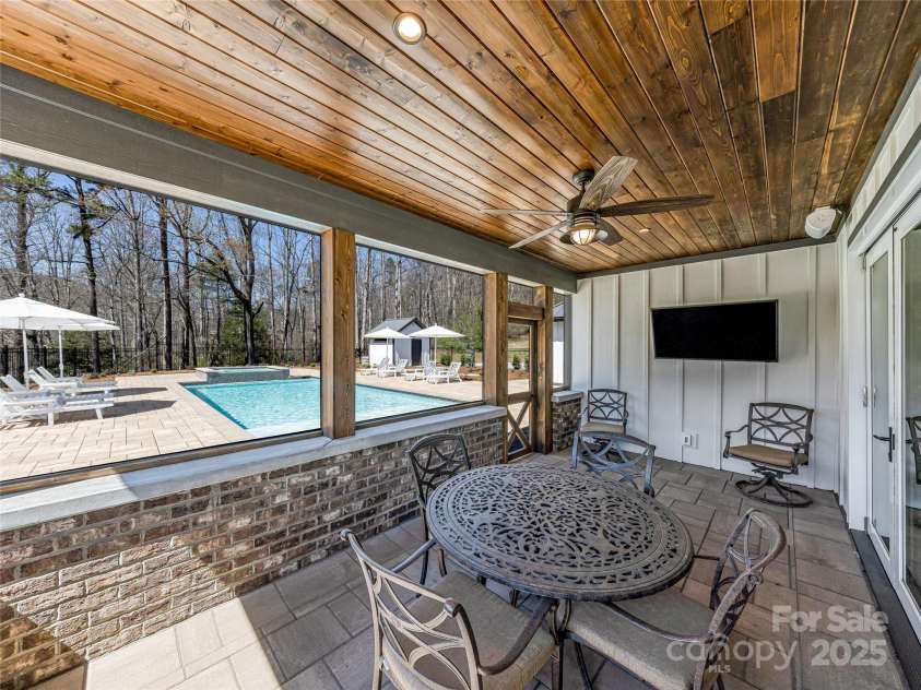 59 Bradford Hill Road, Mills River, NC 28759.  MLS# CAR4241459, YatesRealty ID 16892. Screened back porch with TV that conveys.