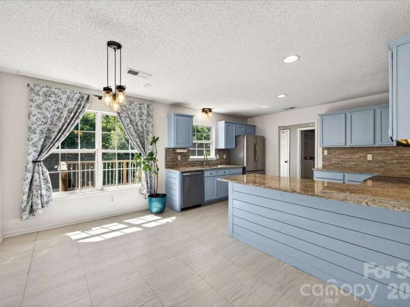 3002 Plyler Mill Road, Monroe, NC 28112.  MLS# CAR4330579, YatesRealty ID 16894. Dinning area and breakfast bar