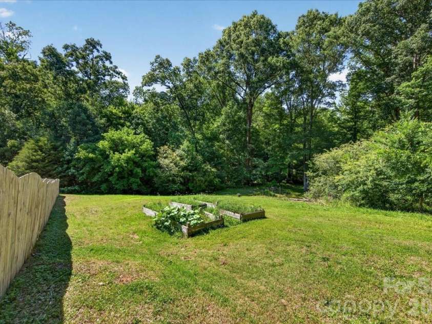 3002 Plyler Mill Road, Monroe, NC 28112.  MLS# CAR4330579, YatesRealty ID 16894. Garden beds with squash growing!