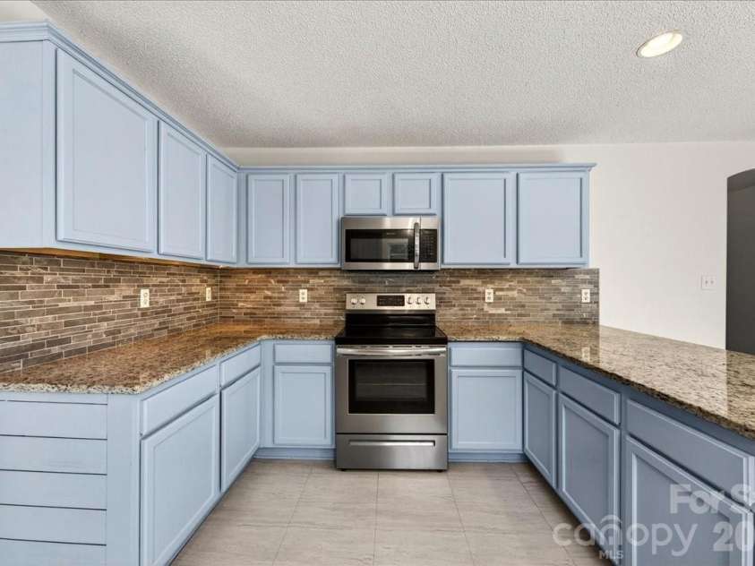 3002 Plyler Mill Road, Monroe, NC 28112.  MLS# CAR4330579, YatesRealty ID 16894. Under cabinet lighting