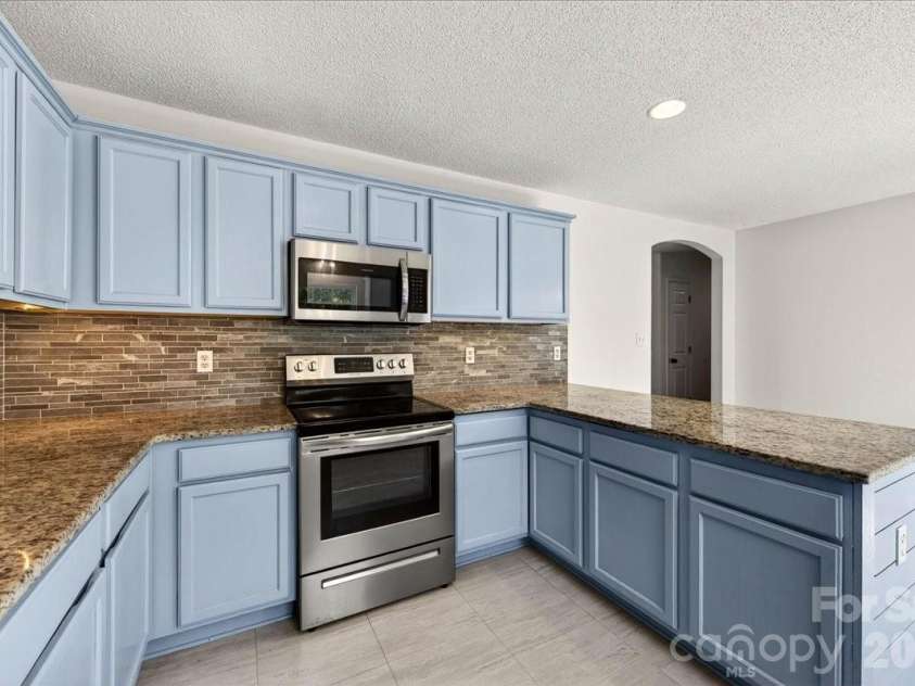 3002 Plyler Mill Road, Monroe, NC 28112.  MLS# CAR4330579, YatesRealty ID 16894. Under cabinet lighting