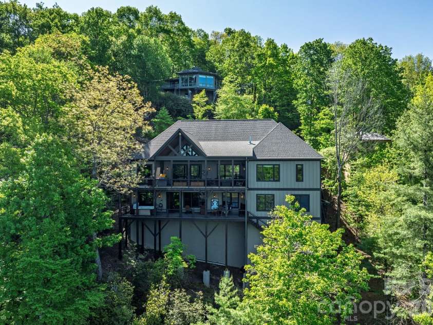 333 Kanasdatsi Drive, Brevard, NC 28712.  MLS# CAR4330137, YatesRealty ID 16902. Rear Elevation with Multi-Level DecksStriking rear elevation showcasing the home’s dramatic mountainside setting, featuring expansive covered and open decks designed for outdoor living and entertaining. Elevated constru