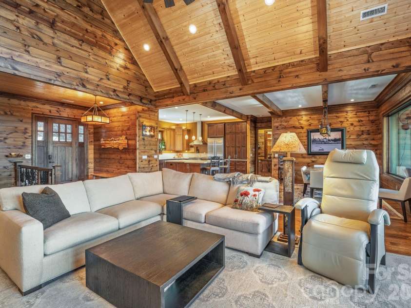 333 Kanasdatsi Drive, Brevard, NC 28712.  MLS# CAR4330137, YatesRealty ID 16902. Spacious open-concept great room featuring vaulted wood ceilings, rich timber accents, and seamless flow into the kitchen and dining areas—perfect for comfortable everyday living and entertaining.