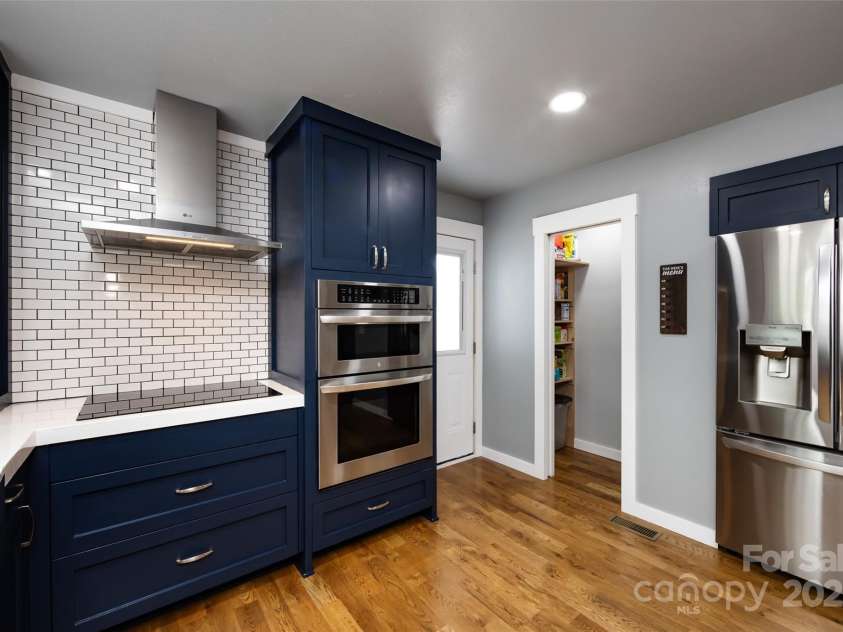 8210 Lantana Drive, Denver, NC 28037.  MLS# CAR4245156, YatesRealty ID 16903. Upgraded Kitchen features concrete counters with epoxy finish, stainless steel appliances ihcluding wall oven, tile back splash, new cabinetry for storage, coffee bar with additional sink & dining area with built in table/