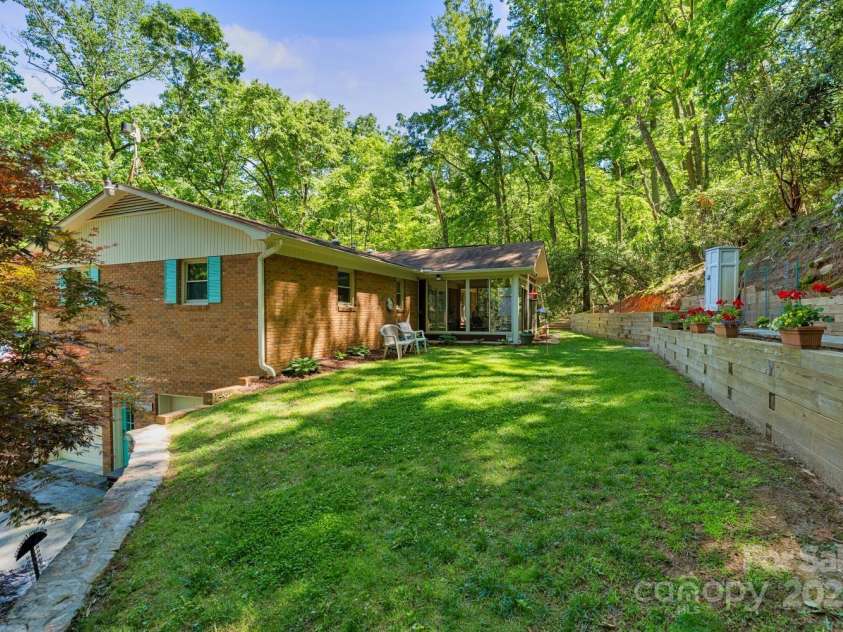 230 Turtle Lane, Hendersonville, NC 28791.  MLS# CAR4260398, YatesRealty ID 16912. Back yard and terraced garden area
