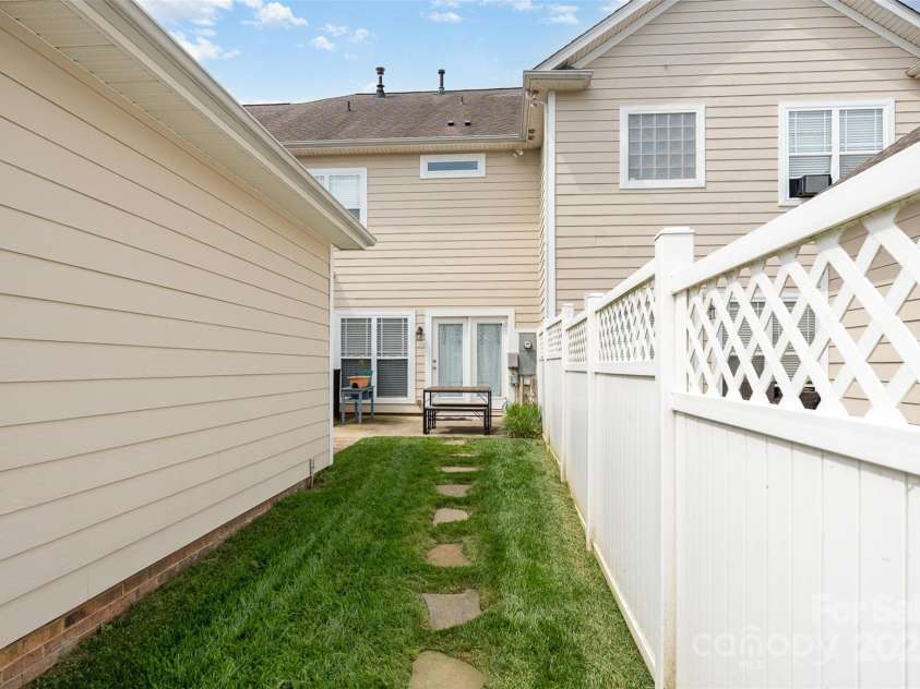 2324 Bonterra Boulevard, Indian Trail, NC 28079.  MLS# CAR4259817, YatesRealty ID 16917. Stepping stones from patio to gate