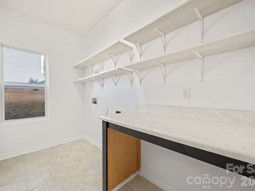 9409 Tradewinds Court, Lancaster, SC 29720.  MLS# CAR4333162, YatesRealty ID 16929. Laundry Room w/folding table
