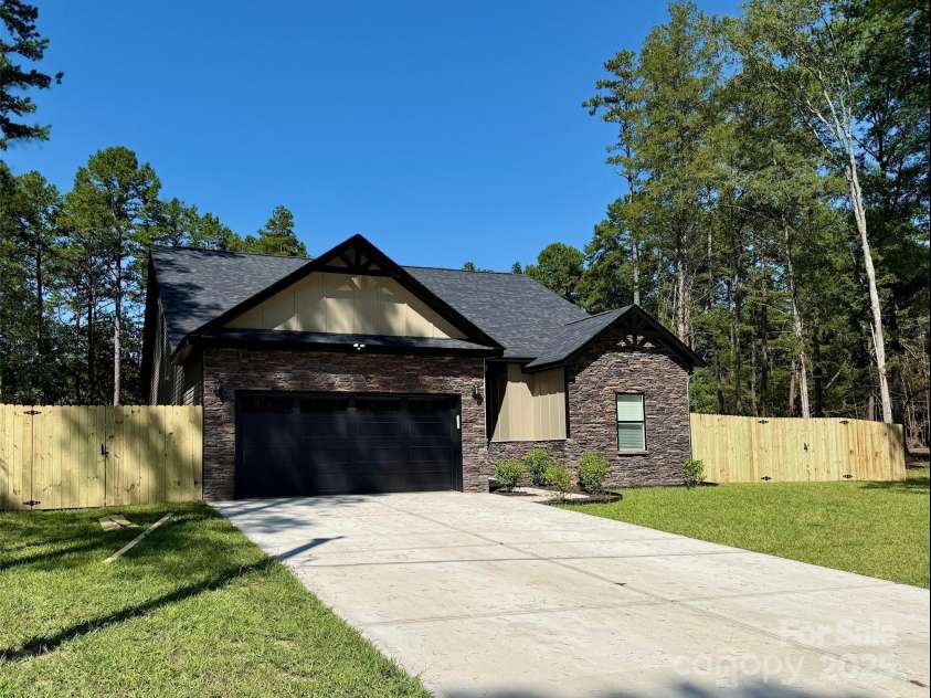 6519 Pargo Road, Charlotte, NC 28216.  MLS# CAR4246671, YatesRealty ID 16937. Front of home with new wood fence