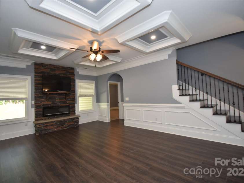 6519 Pargo Road, Charlotte, NC 28216.  MLS# CAR4246671, YatesRealty ID 16937. Living Room. Coffered ceiling. Beautiful floors. FP, ceiling fan. Hardwood stairs to upper level.