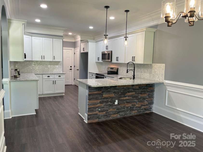 6519 Pargo Road, Charlotte, NC 28216.  MLS# CAR4246671, YatesRealty ID 16937. View of kitchen from dining room