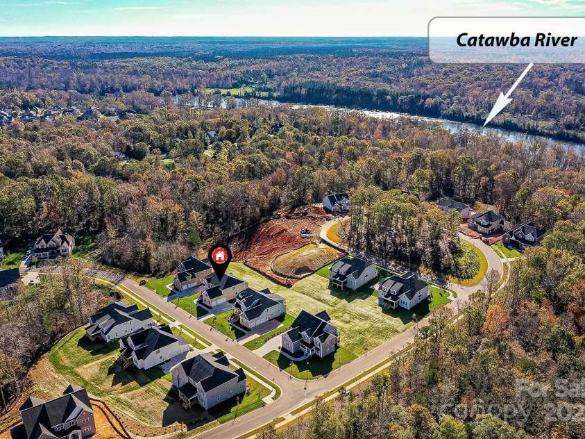 873 Penny Royal Avenue, Fort Mill, SC 29715.  MLS# CAR4234425, YatesRealty ID 16944. 2024 photo of Drone View showing construction behind which has commenced, and after completion of last homes, the neighborhood will be built-out. View of Catawba River