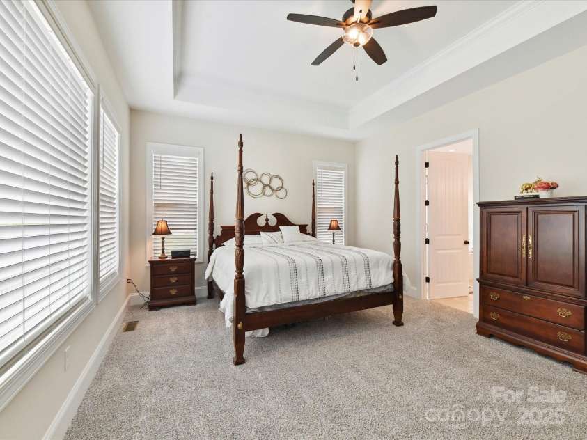 873 Penny Royal Avenue, Fort Mill, SC 29715.  MLS# CAR4234425, YatesRealty ID 16944. Primary Ceiling Fan and Carriage Doors to Primary Bath