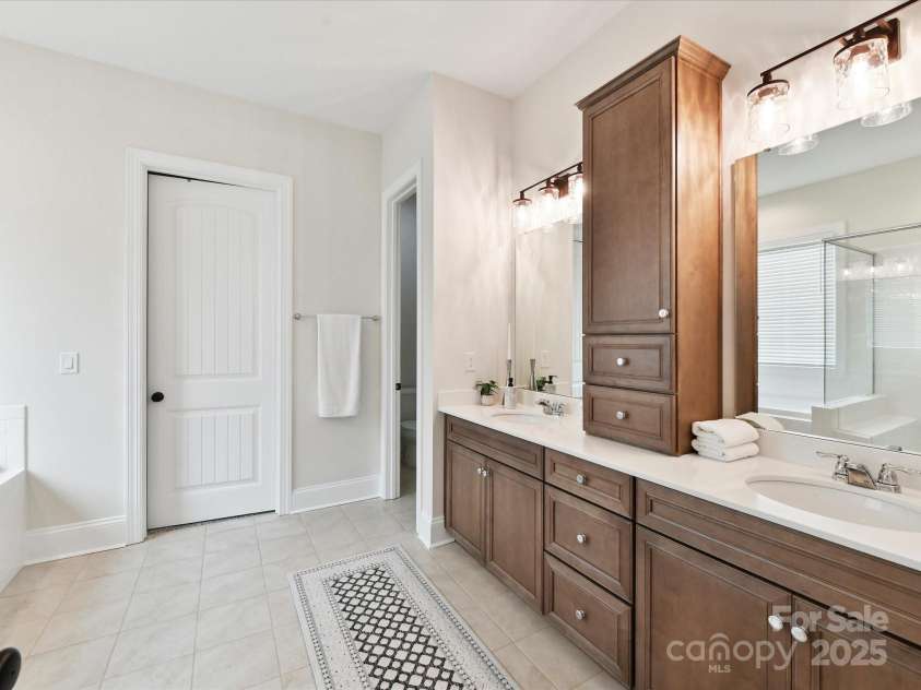 873 Penny Royal Avenue, Fort Mill, SC 29715.  MLS# CAR4234425, YatesRealty ID 16944. Primary Vanity with Linen Tower. Tiled Flooring