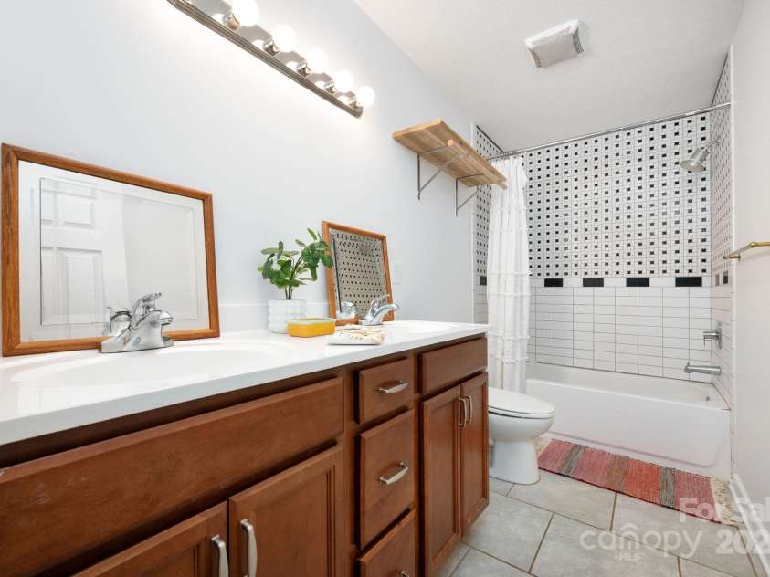 205 Cowan Cove Road, Asheville, NC 28806.  MLS# CAR4265297, YatesRealty ID 16948. Full bathroom with tiled shower tub combo