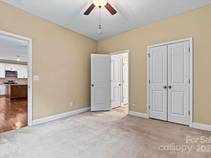7020 Cedar Ridge Court, Mount Holly, NC 28120.  MLS# CAR4256213, YatesRealty ID 16957. 3rd bedroom is connected to hall bath, providing a mini-primary suite.  Perfect for guests.