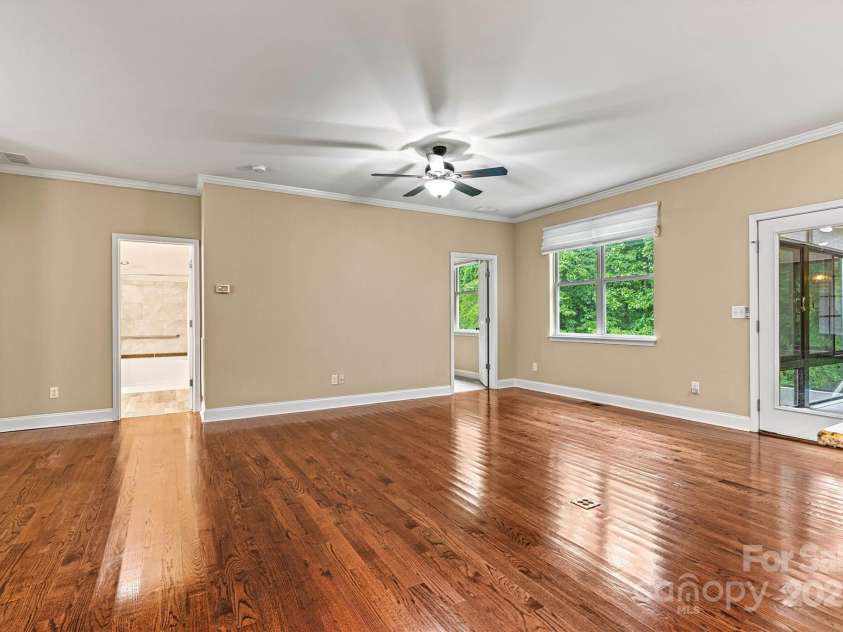 7020 Cedar Ridge Court, Mount Holly, NC 28120.  MLS# CAR4256213, YatesRealty ID 16957. Another view of Living Area from Kitchen.  Rear door carries you into the heated and cooled Sunroom.  Hardwood floors are absolutely beautiful!