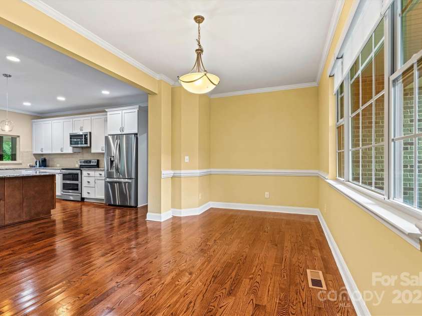 7020 Cedar Ridge Court, Mount Holly, NC 28120.  MLS# CAR4256213, YatesRealty ID 16957. Another view of the large Dining Room, located on the front of the house.  Triple windows bring light in, making the space feel even larger.  Chair railing adds a bit of formality to the room.