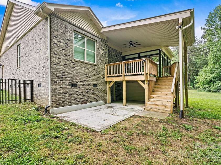 7020 Cedar Ridge Court, Mount Holly, NC 28120.  MLS# CAR4256213, YatesRealty ID 16957. Concrete patio area at the bottom of the steps, plus storage underneath the deck.