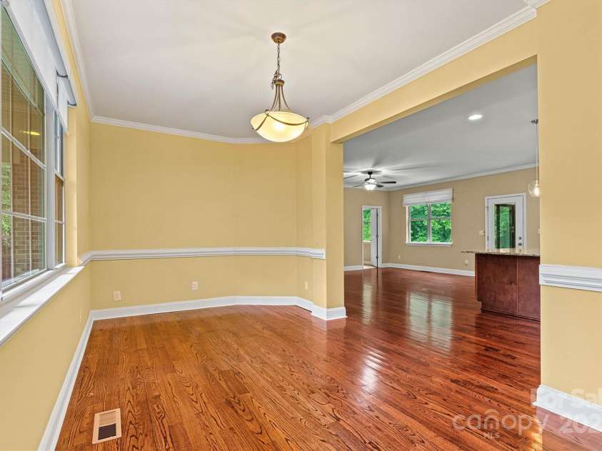 7020 Cedar Ridge Court, Mount Holly, NC 28120.  MLS# CAR4256213, YatesRealty ID 16957. Formal Dining Room is separated a bit from the Kitchen, making it a special place for gathering.  Large room can accommodate a huge dining table and accessory pieces.
