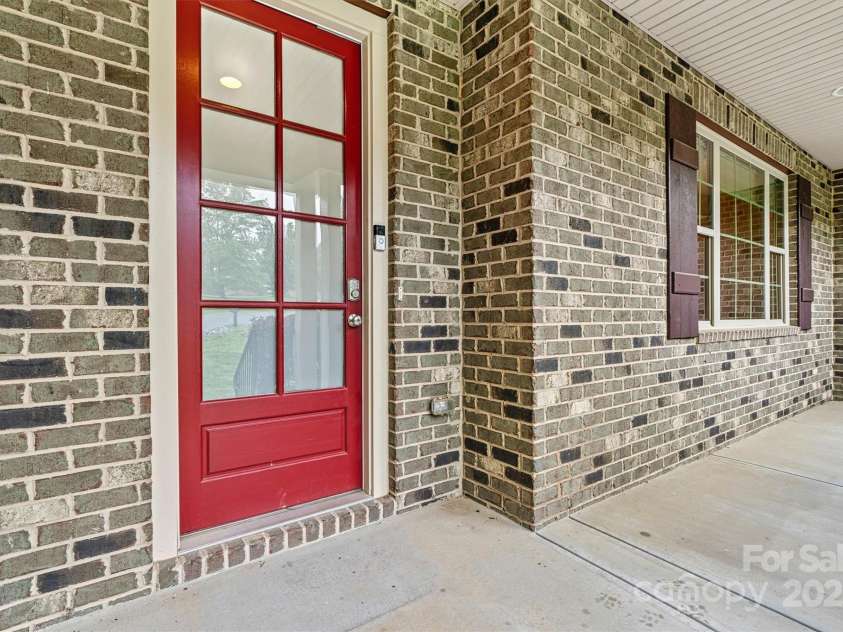 7020 Cedar Ridge Court, Mount Holly, NC 28120.  MLS# CAR4256213, YatesRealty ID 16957. Front porch is ready for your rocking chairs!